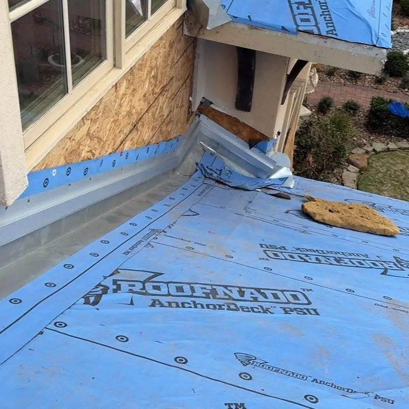 New metal wall flashing installed where the roof meets the wall, over high-temp peel-and-stick underlayment